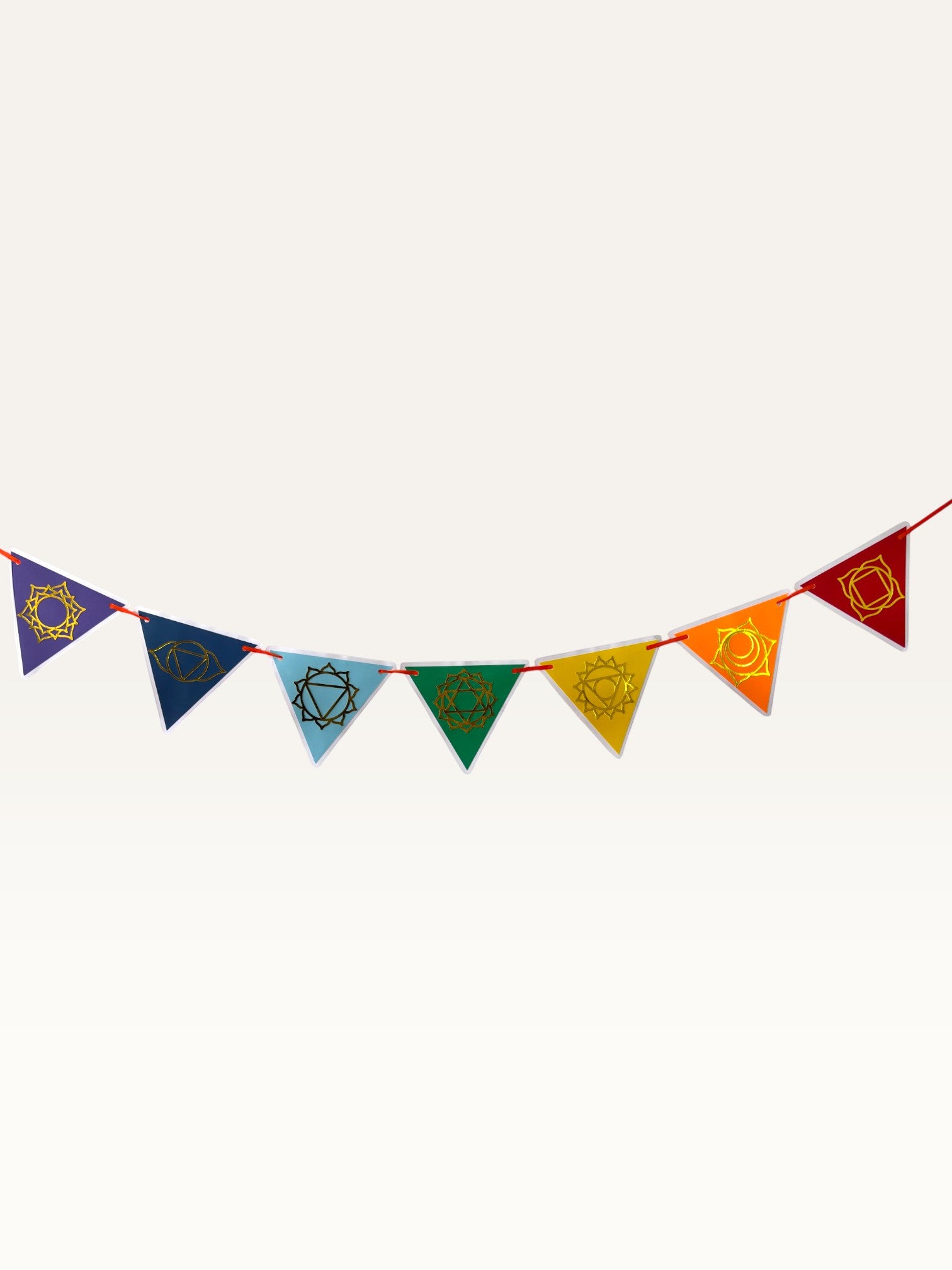 Paper Party Studio seven chakra garland featuring triangular discs with gold foil symbols in traditional color order.