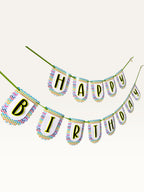 Paper Party Studio Happy Birthday banner with multicolour chevron border on white scalloped paper flags and green cord