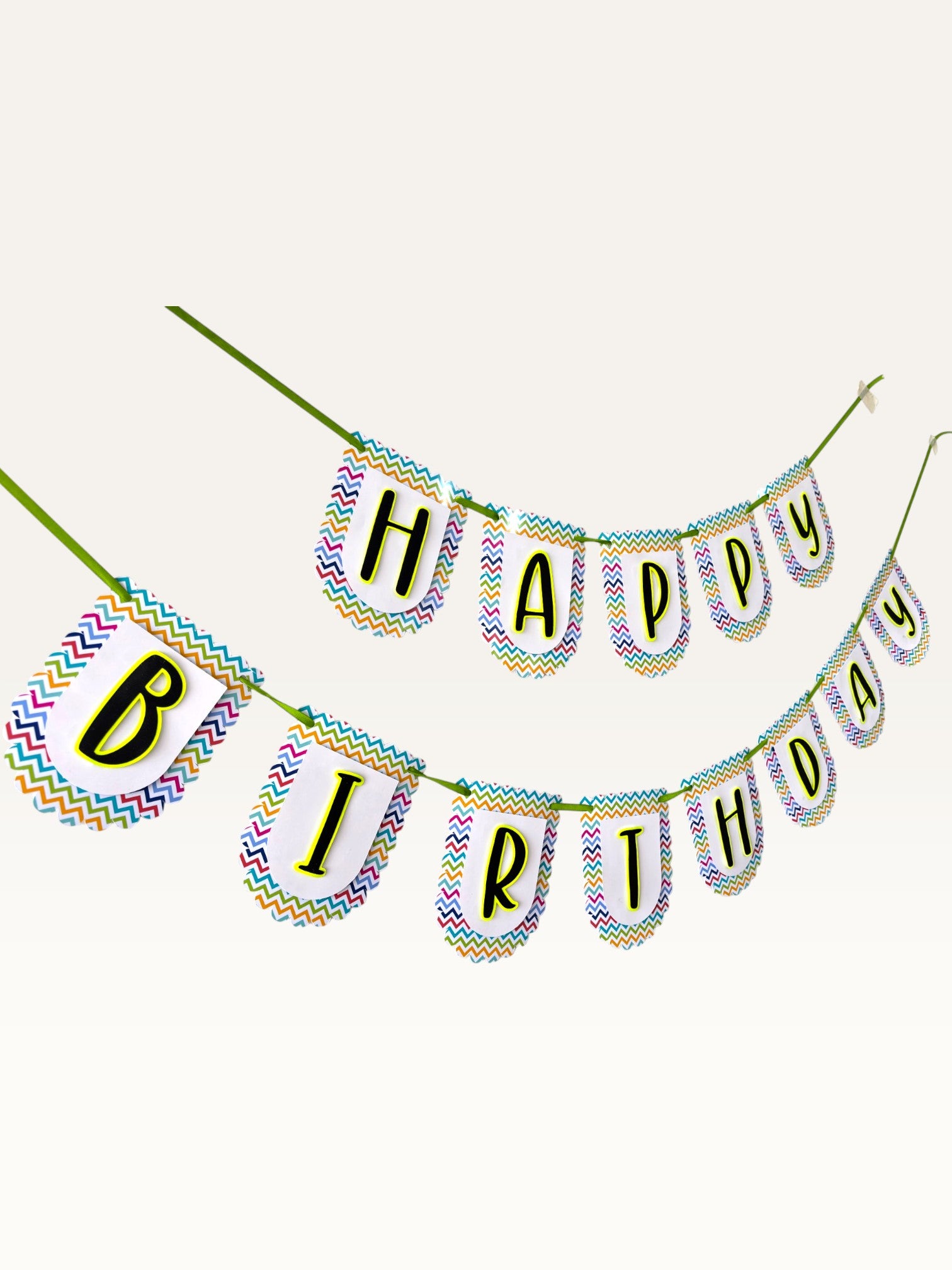 Paper Party Studio Happy Birthday banner with multicolour chevron border on white scalloped paper flags and green cord
