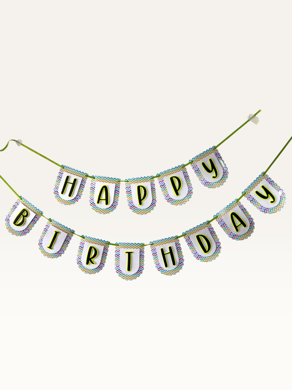 Paper Party Studio Happy Birthday banner with white scalloped paper flags, multicolour chevron borders, and black letters.