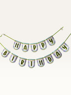 Paper Party Studio Happy Birthday banner with white scalloped paper flags, multicolour chevron borders, and black letters.