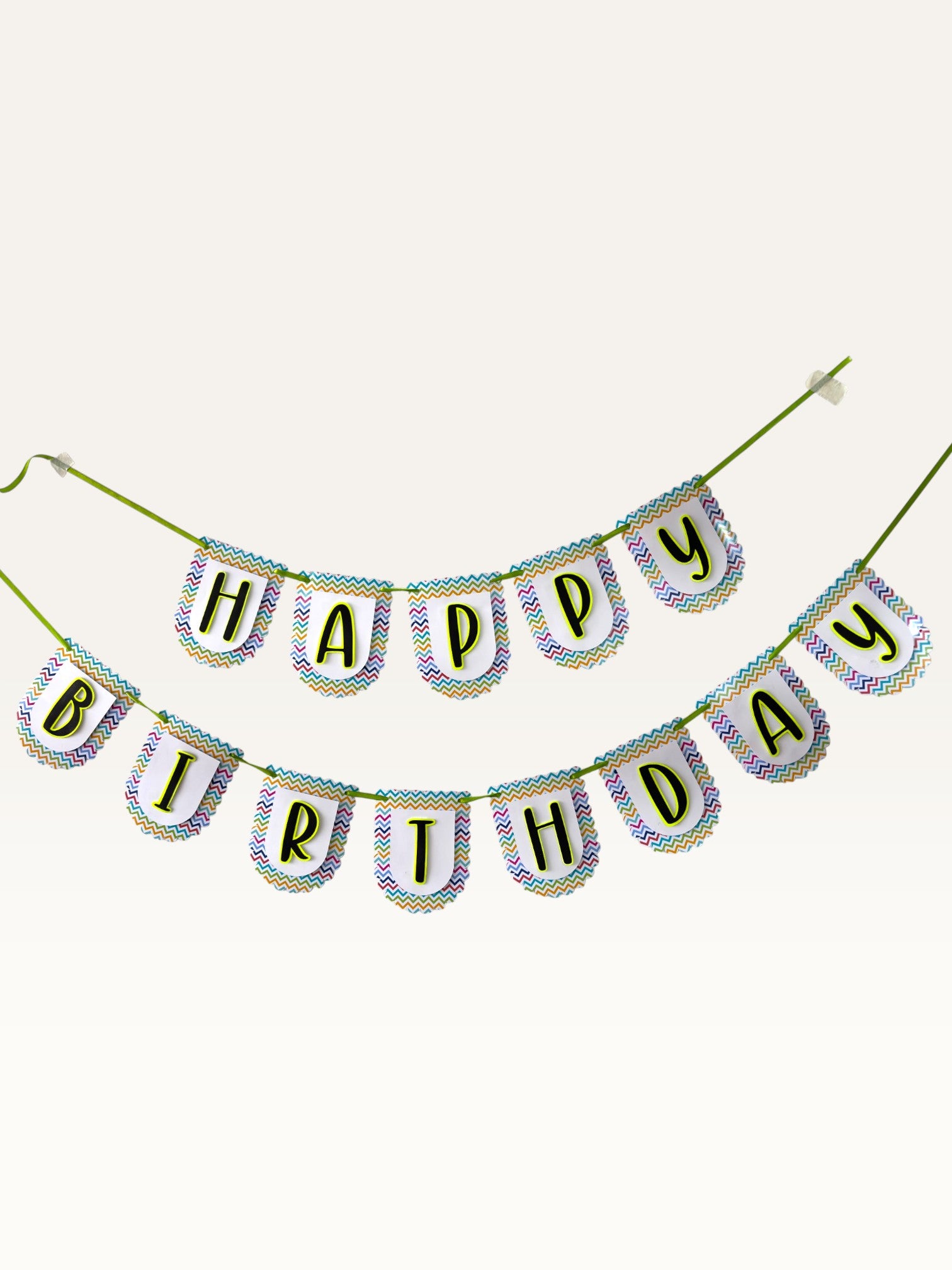 Paper Party Studio Happy Birthday banner with white scalloped paper flags, multicolour chevron borders, and black letters.