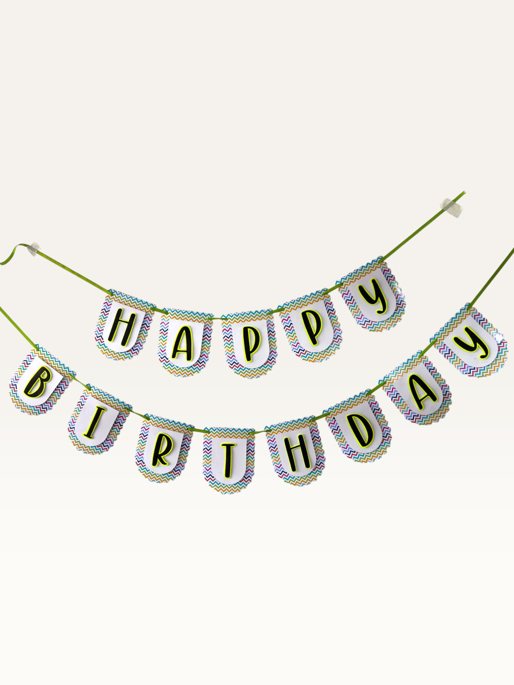 Paper Party Studio Happy Birthday banner with multicolour chevron scalloped tags and black letters on green cord