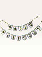 Paper Party Studio Happy Birthday banner with multicolour chevron scalloped tags and black letters on green cord