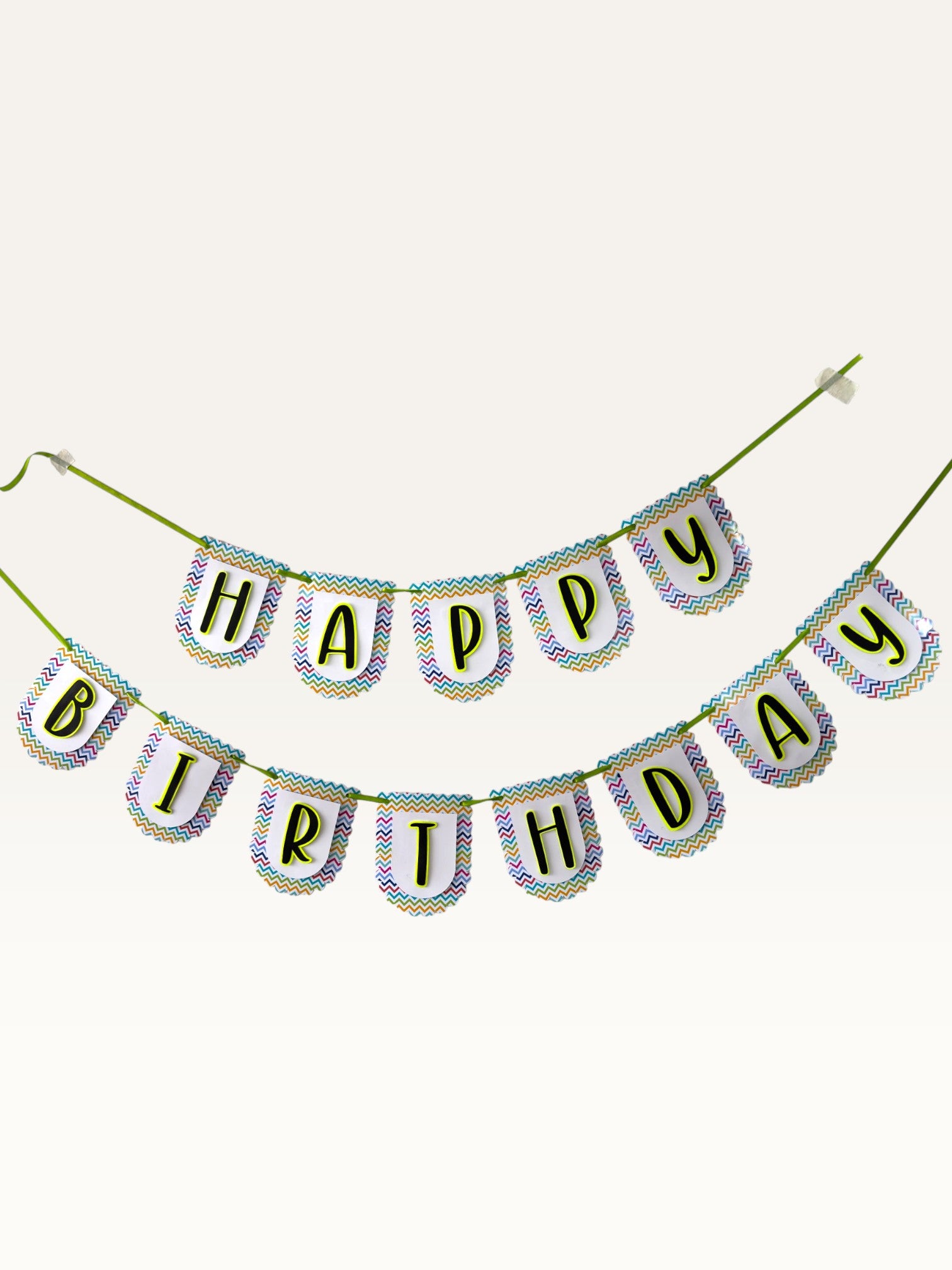 Paper Party Studio Happy Birthday banner with multicolour chevron scalloped tags and black letters on green cord