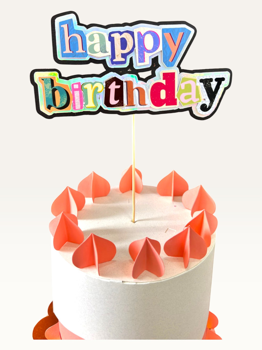 Paper Party Studio maximalist happy birthday cake topper with holographic magazine-style collage letters on a cake.