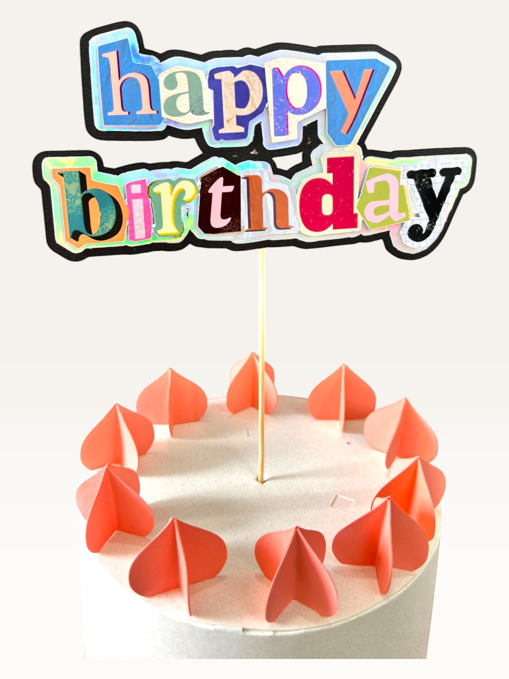 Paper Party Studio maximalist happy birthday cake topper with holographic magazine-style collage letters on a cake.