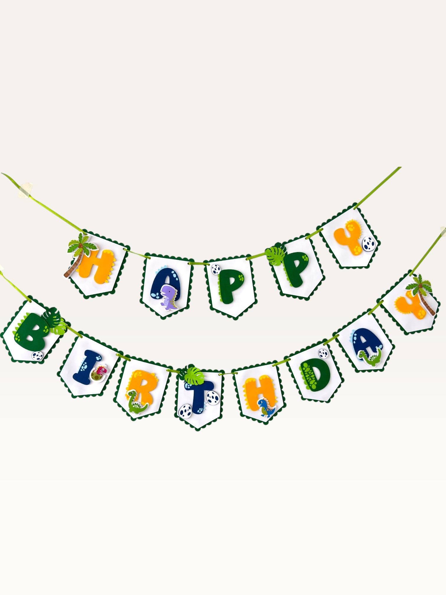 Paper Party Studio dinosaur Happy Birthday banner with scalloped white flags, green borders, and jungle dino motifs.