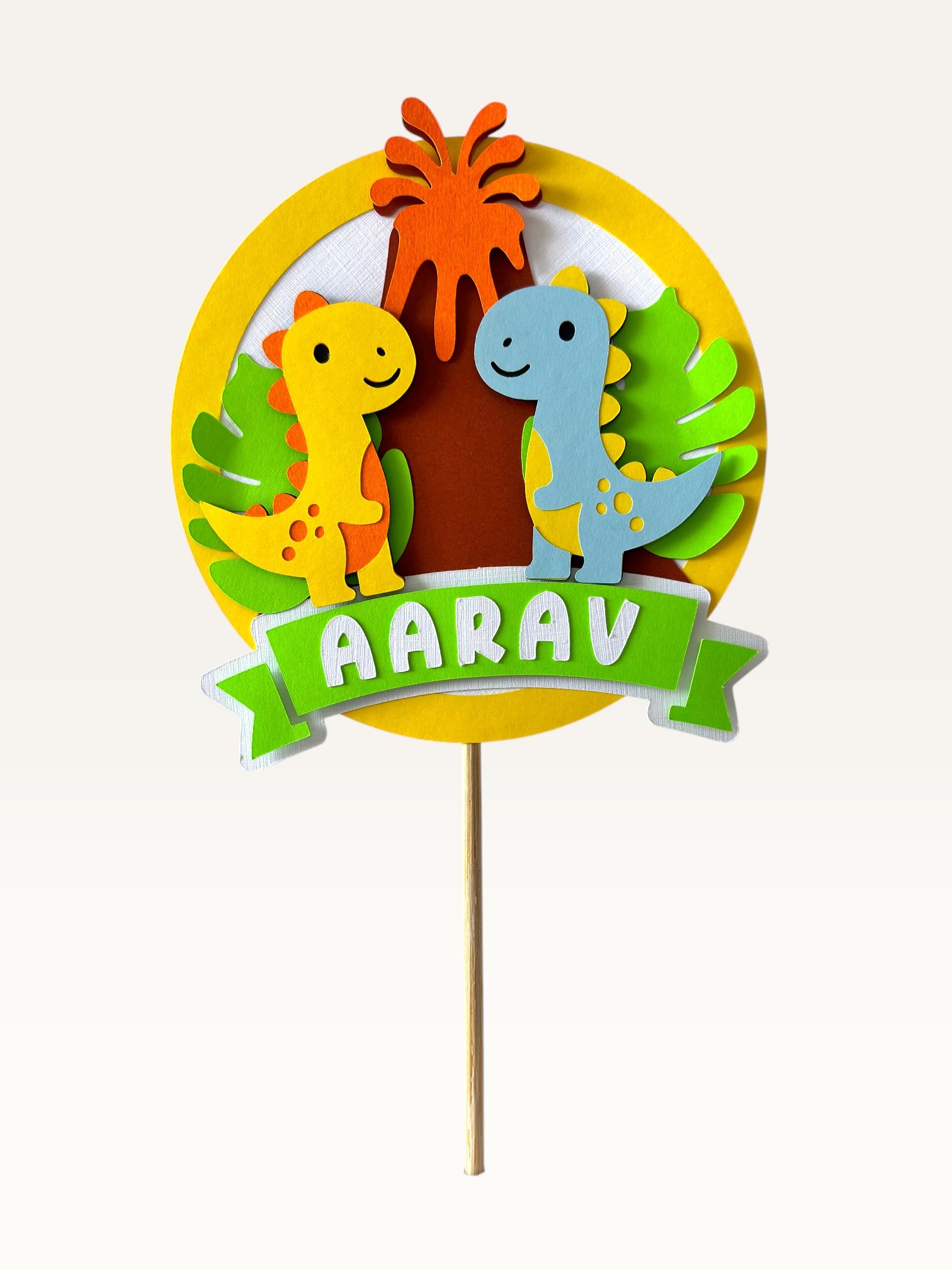 Paper Party Studio personalised dinosaur cake topper with friendly dinos and tropical leaves