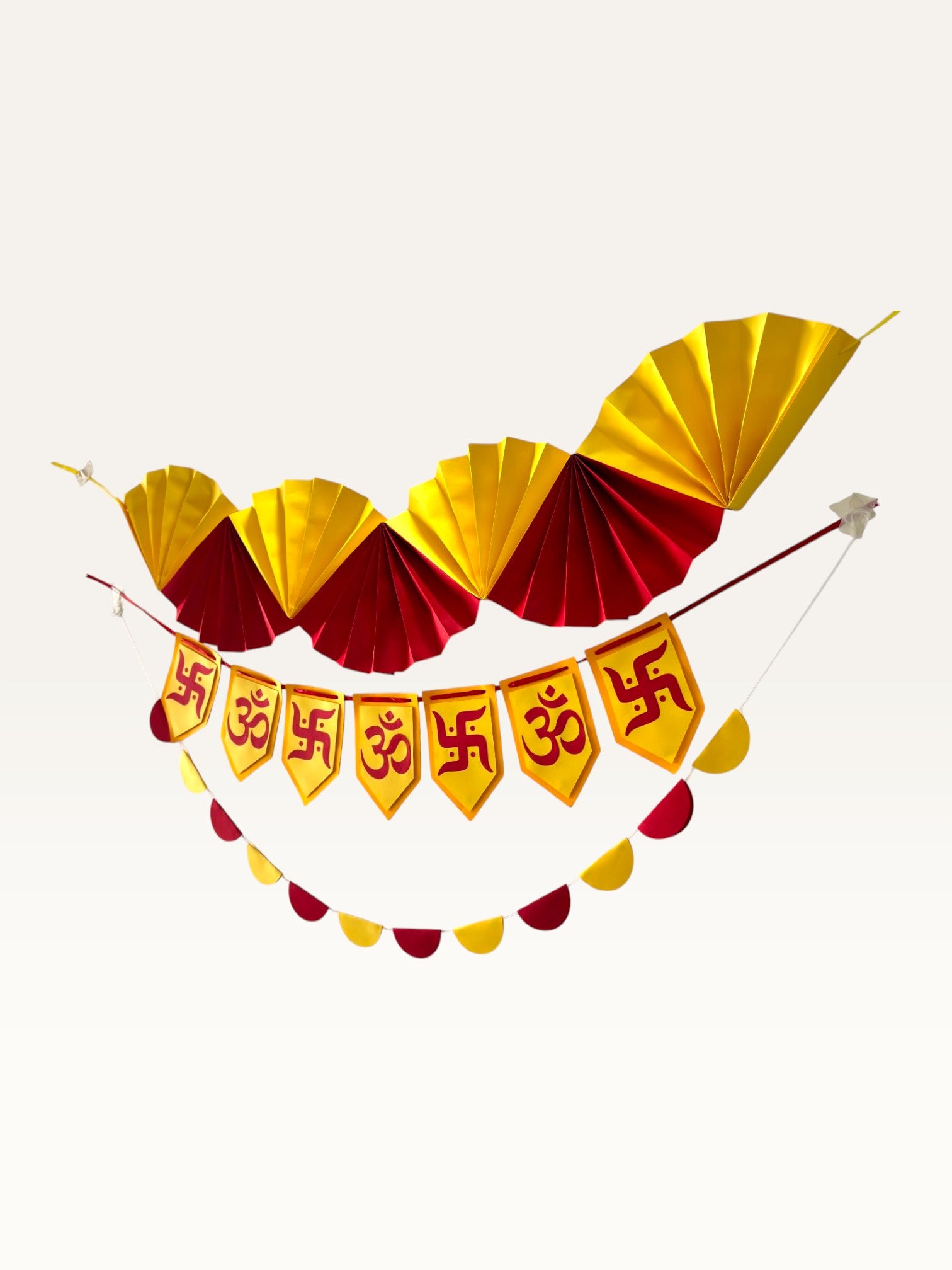 Paper Party Studio yellow and red paper Diwali decoration set with Om and Swastik banner, fan garland, and scallops.