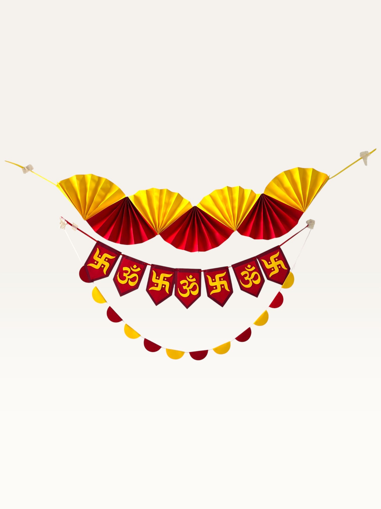Paper Party Studio festive decoration set with yellow and red paper fans, Om and Swastik banner, and scallop garland.