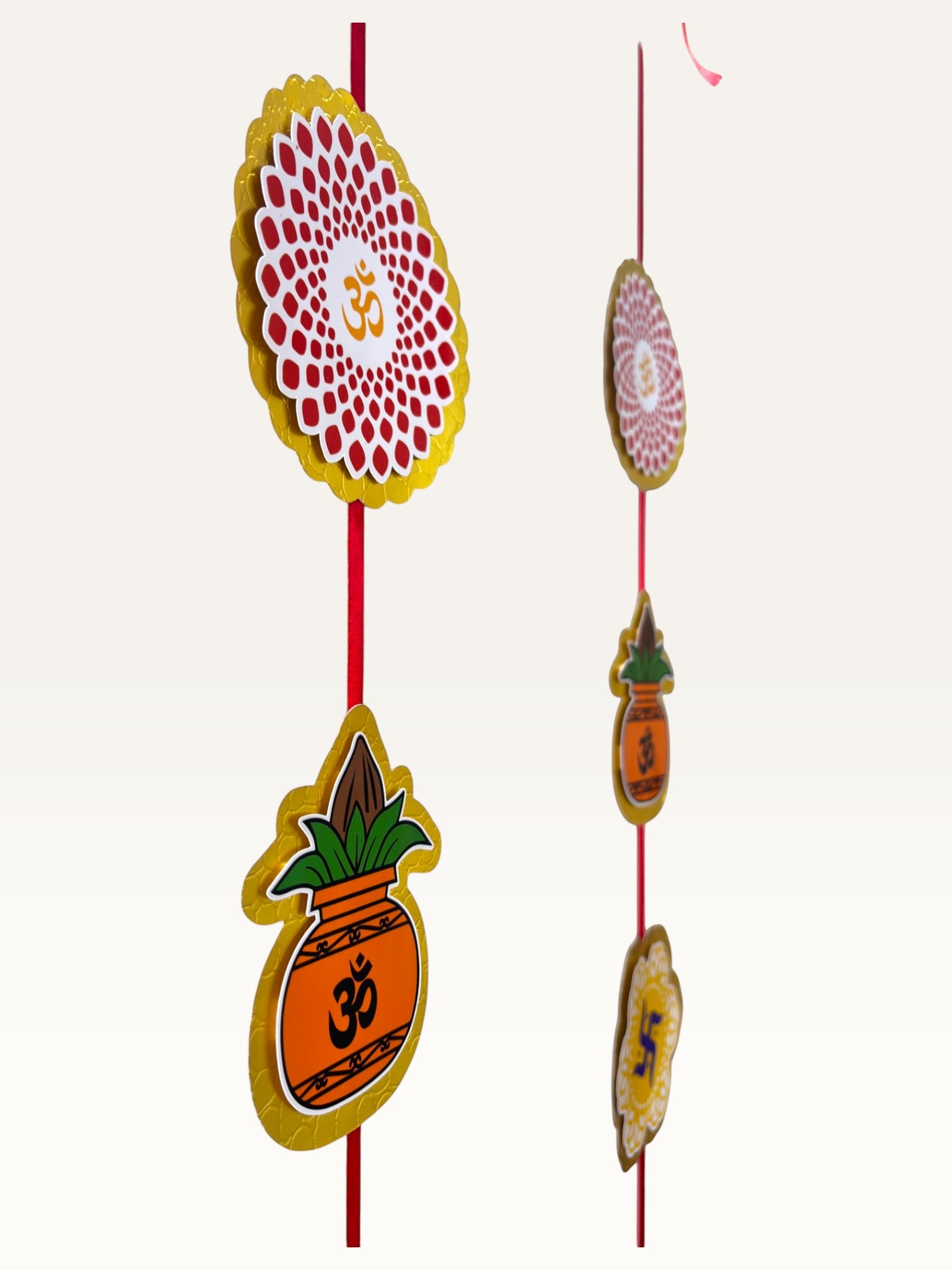 Paper Party Studio festive door hanging with layered cardstock auspicious motifs on a red cord for Diwali decor.