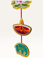 Paper Party Studio festive door hanging featuring layered cardstock motifs of a lotus, diya, and elephant on a red cord.