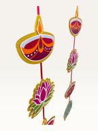 Paper Party Studio festive door hanging featuring layered cardstock motifs like diyas and lotuses on a red cord.