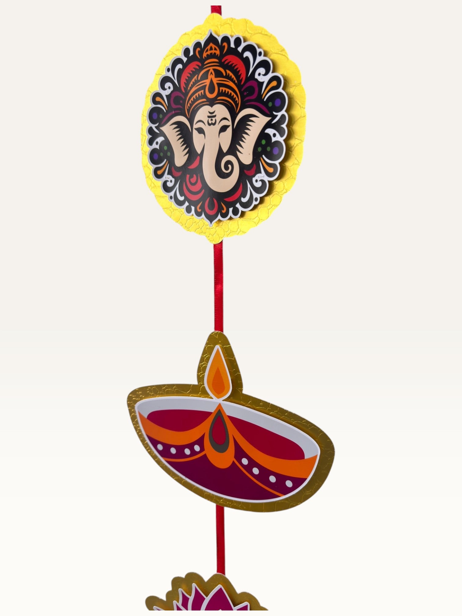 Paper Party Studio handcrafted festive door hanging with Ganesha and diya motifs on a red cord with gold borders.