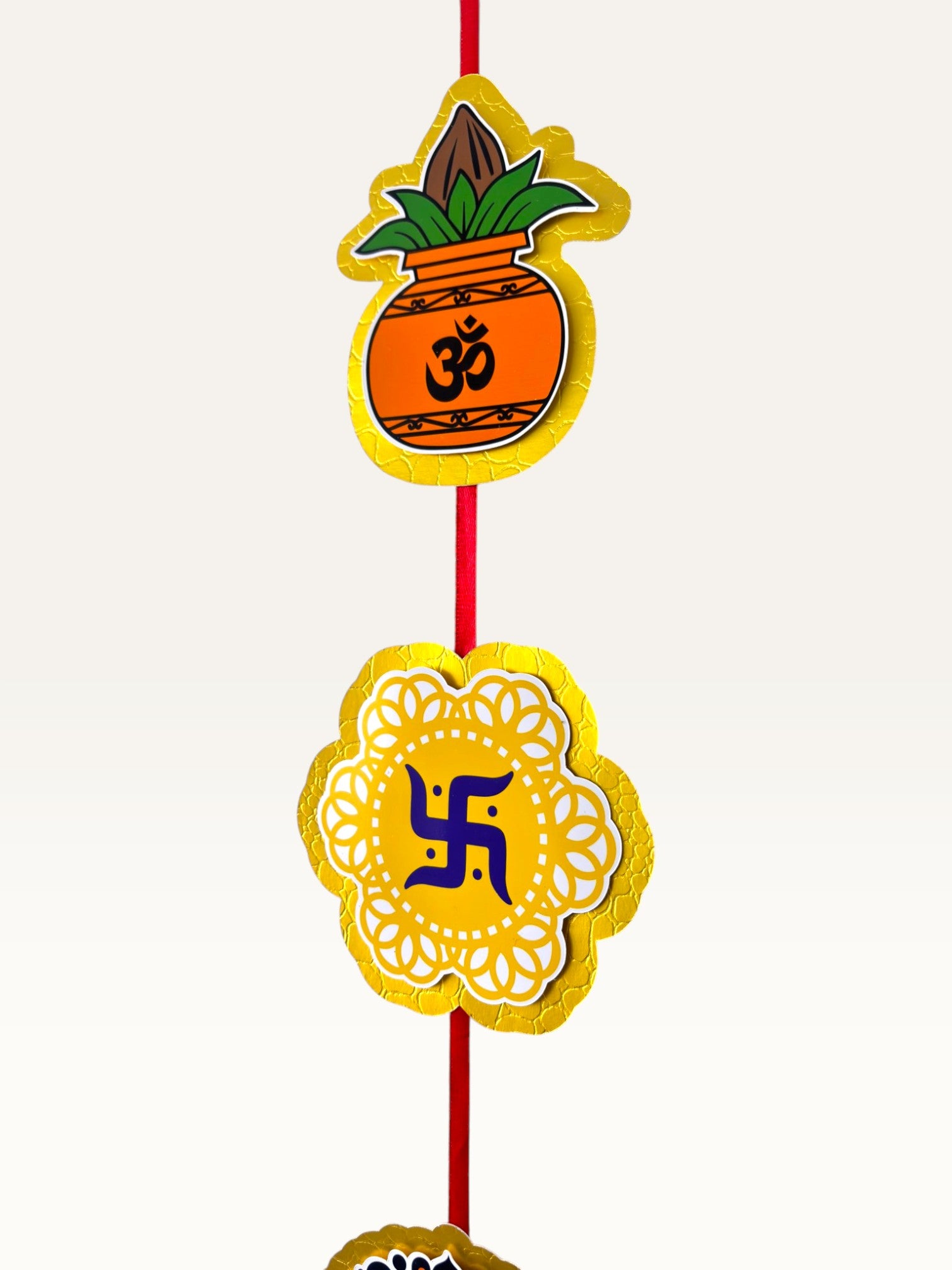 Paper Party Studio festive door hanging featuring layered cardstock motifs of a Kalash and Swastik with gold borders.