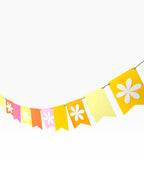 Paper Party Studio flower bunting with fishtail flags in yellow, pink, orange, and red, featuring white flower cut-outs.