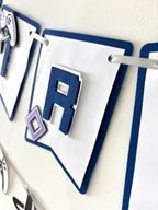 Paper Party Studio gamer birthday banner with white and navy layered paper flags, silver edges, and controller icons.