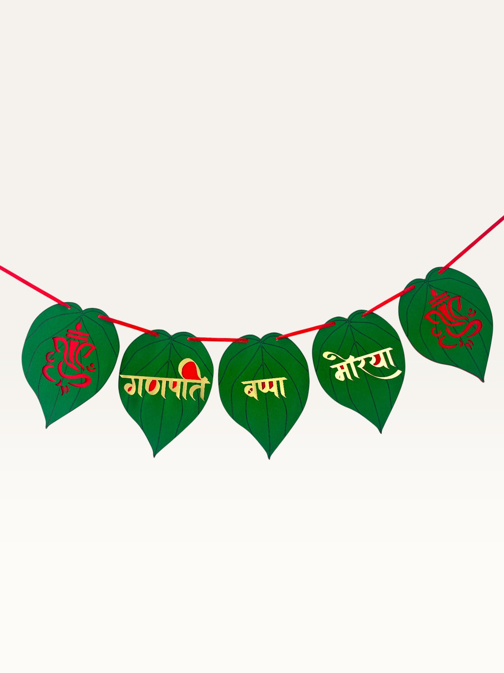 Paper Party Studio Ganpati Bappa Morya banner with green paan-leaf paper flags, gold and red lettering, and Ganesha.
