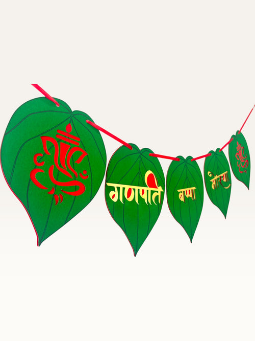 Paper Party Studio Ganpati Bappa Morya banner featuring green paan-leaf paper flags with gold and red Ganesha motifs.