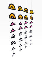 Paper Party Studio boho backdrop set with 4 strands of geometric paper hangings in black, yellow, pink, and white.