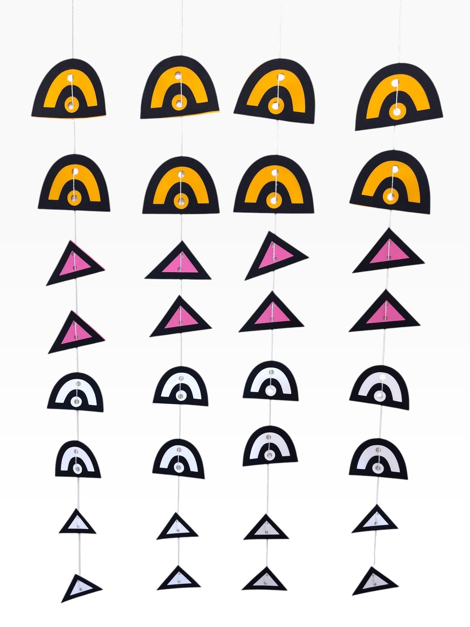 Paper Party Studio geometric paper hanging backdrop set with arches and triangles in black, yellow, pink, and white.