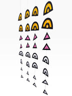 Paper Party Studio geometric paper hanging backdrop set with arches and triangles in black, yellow, pink, and white.