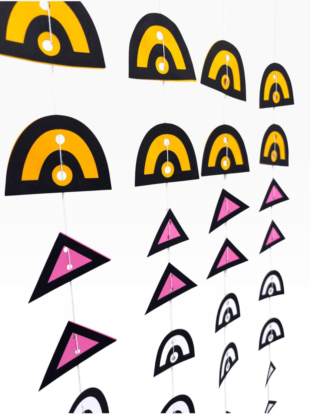 Paper Party Studio geometric paper hanging backdrop set with arches and triangles in black, yellow, pink, and white.