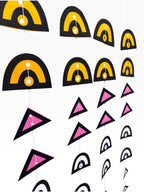 Paper Party Studio geometric paper hanging backdrop set with arches and triangles in black, yellow, pink, and white.
