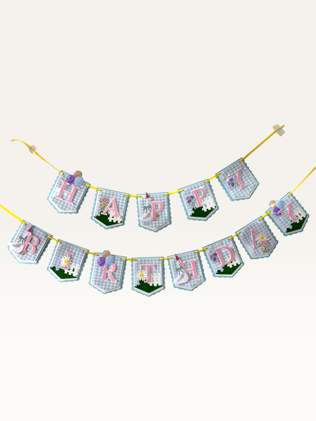 Paper Party Studio Gingham Garden birthday banner with blue checkered flags, pink letters, and floral decorations.