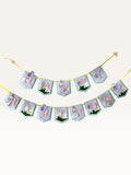 Paper Party Studio Gingham Garden birthday banner with blue checkered flags, pink letters, and floral decorations.