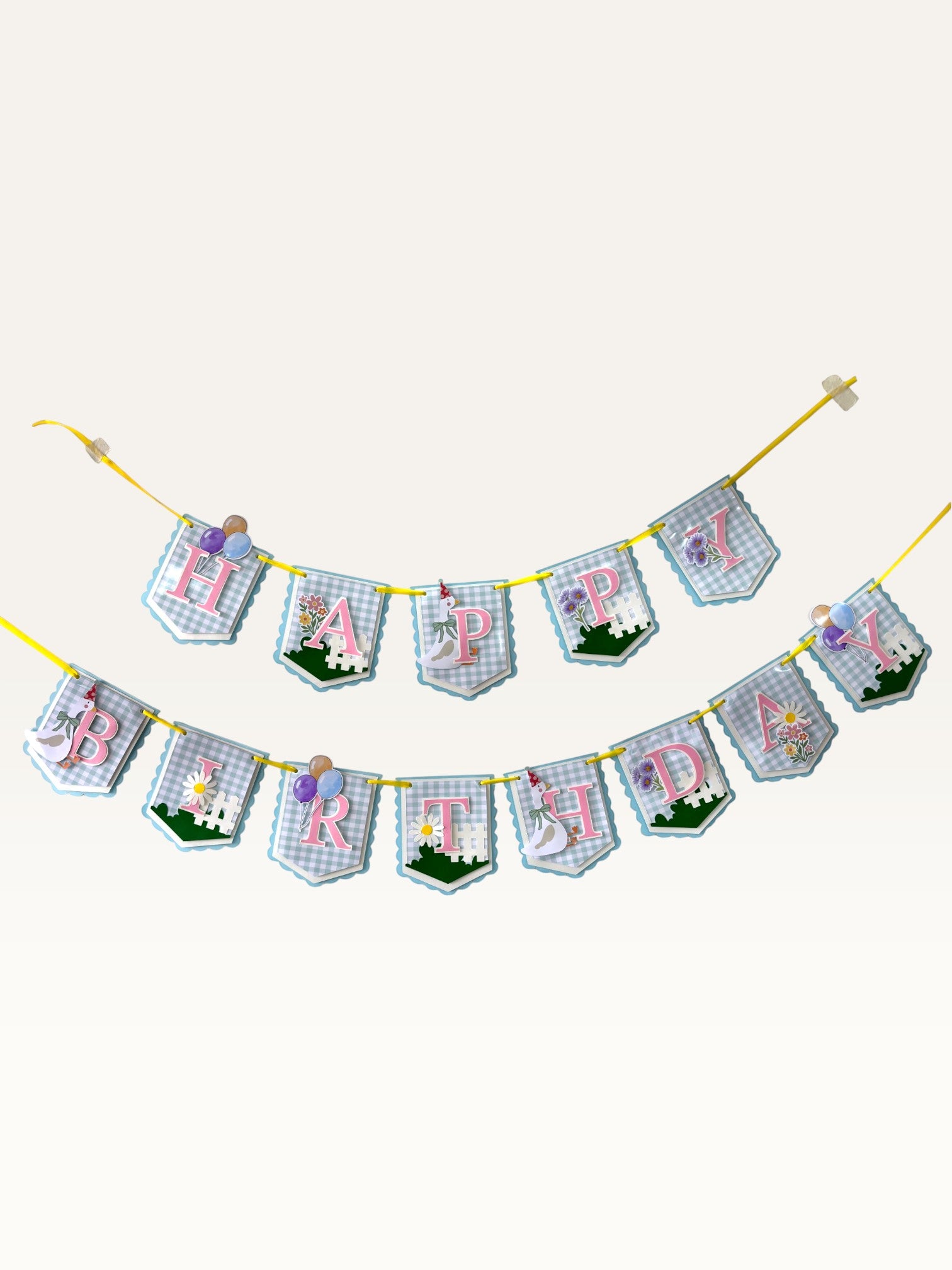 Paper Party Studio Gingham Garden birthday banner with blue checkered flags, pink letters, and floral decorations.