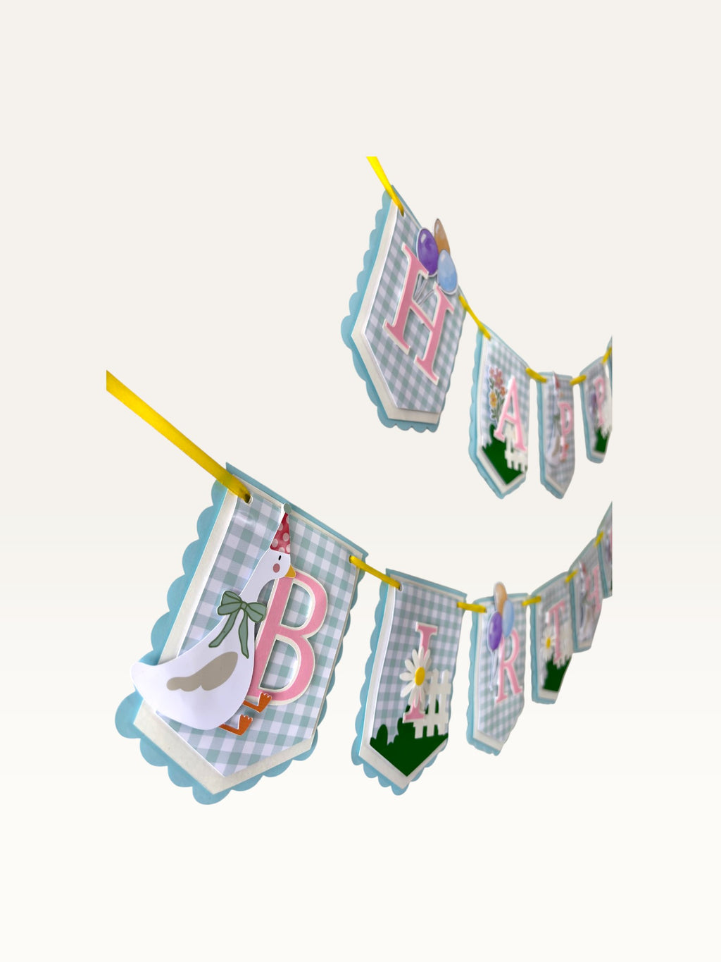 Paper Party Studio Gingham Garden birthday banner with blue check flags, pink letters, and a cute party-hat goose.