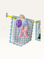 Paper Party Studio birthday banner featuring blue gingham paper flags with pink letters and balloon illustrations.