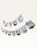 Paper Party Studio Gingham Garden birthday banner with blue check flags, pink letters, daisies, and a party goose.