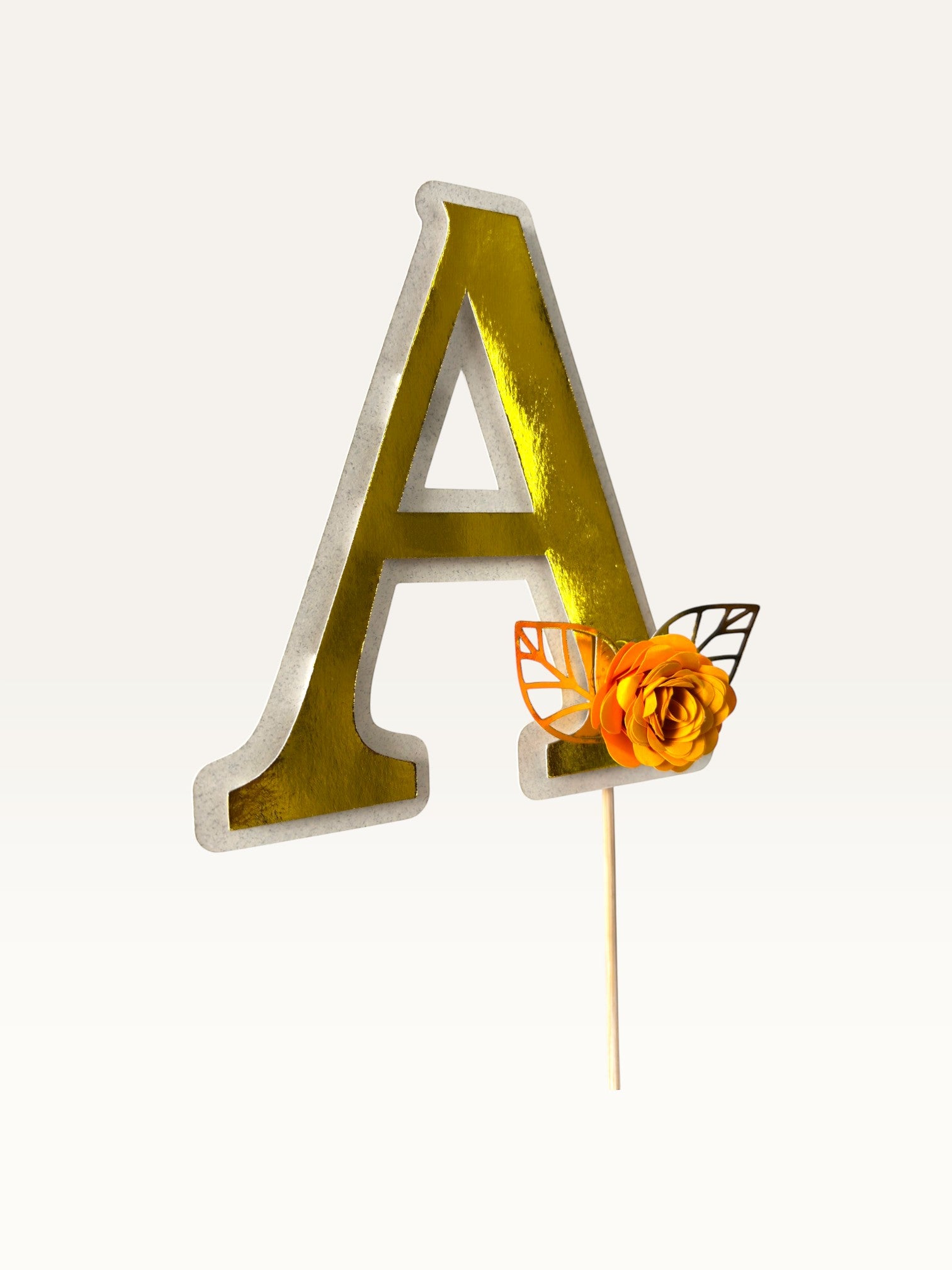 Paper Party Studio personalised gold foil letter A cake topper with a handmade orange paper flower and foil leaf.