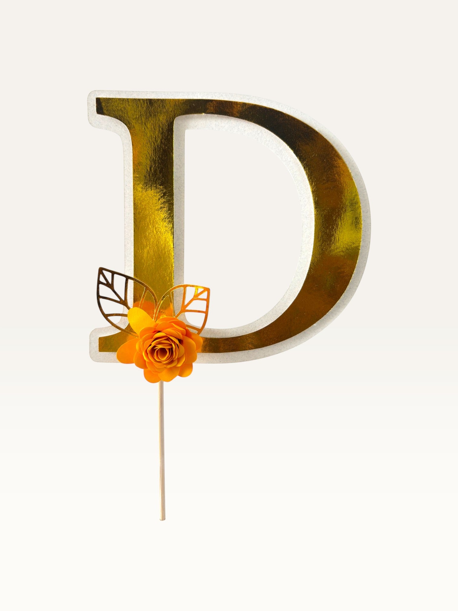 Paper Party Studio personalised gold foil letter D cake topper with a handmade orange paper flower and gold leaf.