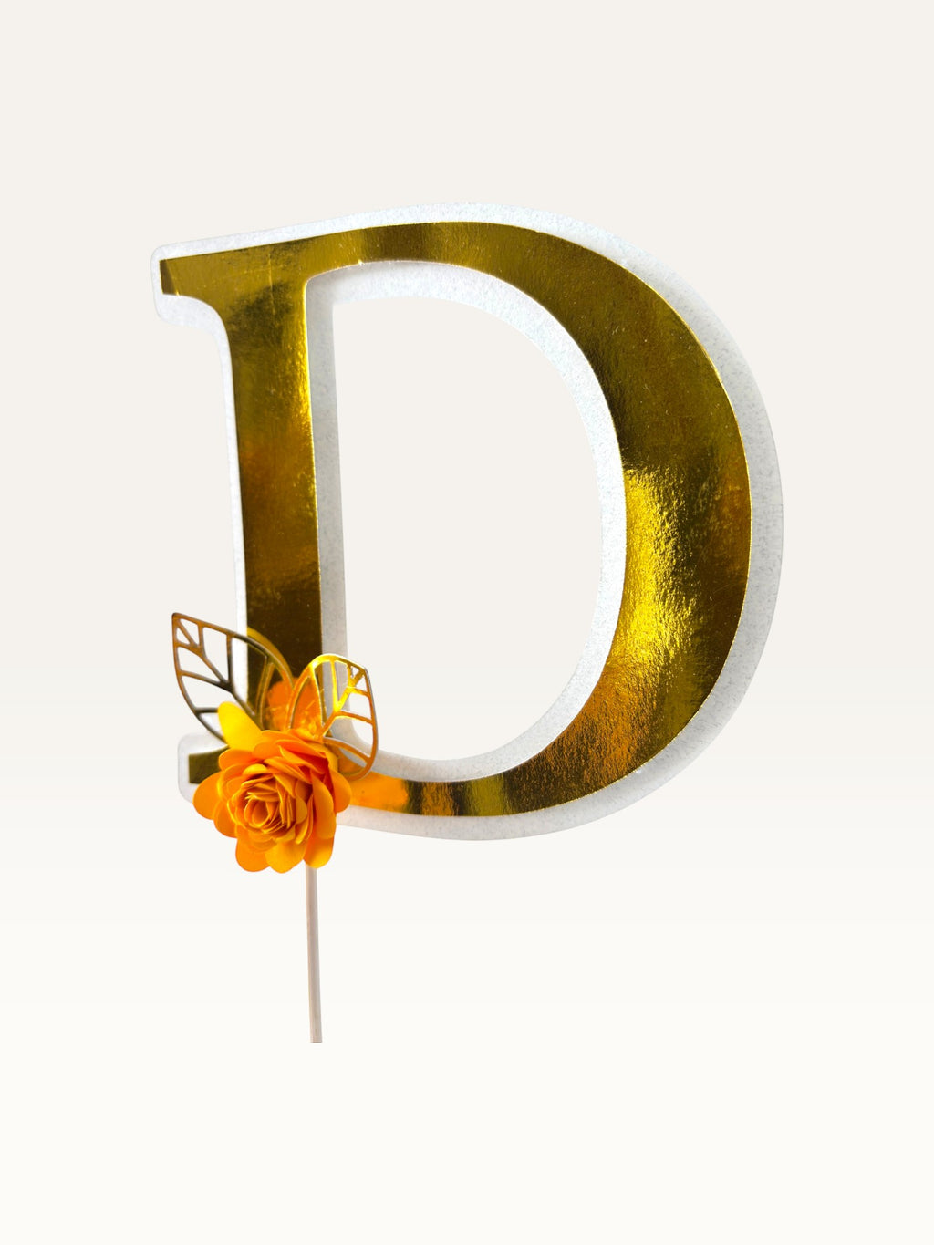 Paper Party Studio personalised gold foil letter D cake topper with a handmade orange paper flower and gold leaf.