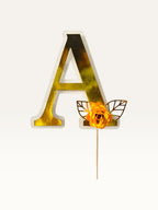Paper Party Studio personalised gold foil letter A cake topper with a handmade orange paper flower and foil leaf.