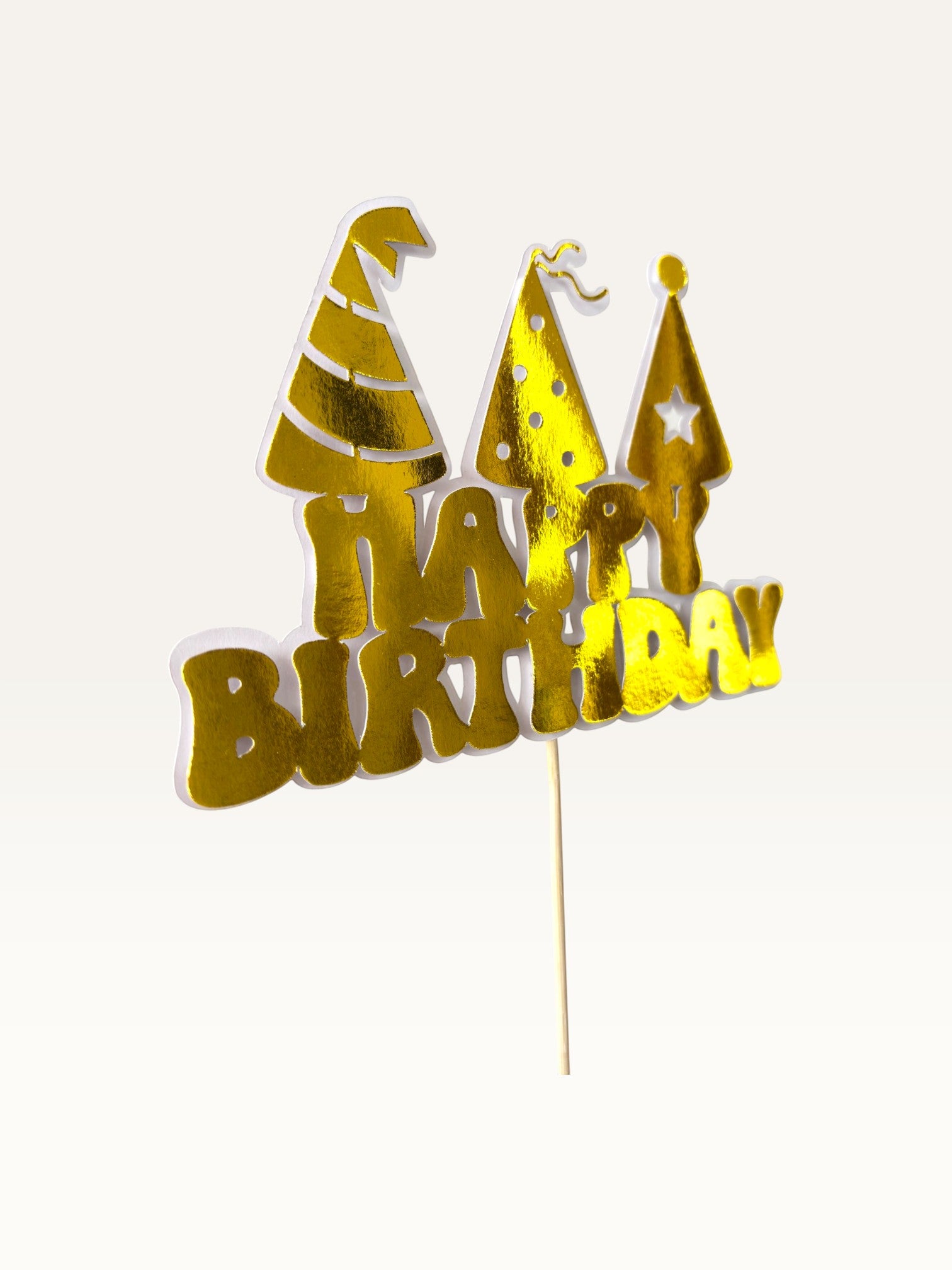 Paper Party Studio golden Happy Birthday cake topper with three party hat cut-outs on a wooden pick.