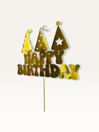 Paper Party Studio golden Happy Birthday cake topper featuring three party hats on a wooden pick with white backing.