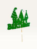 Paper Party Studio green Happy Birthday cake topper with three party hats on a wooden pick
