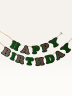 Paper Party Studio green and brown layered paper Happy Birthday banner with dimensional cut-out letters on a cord.