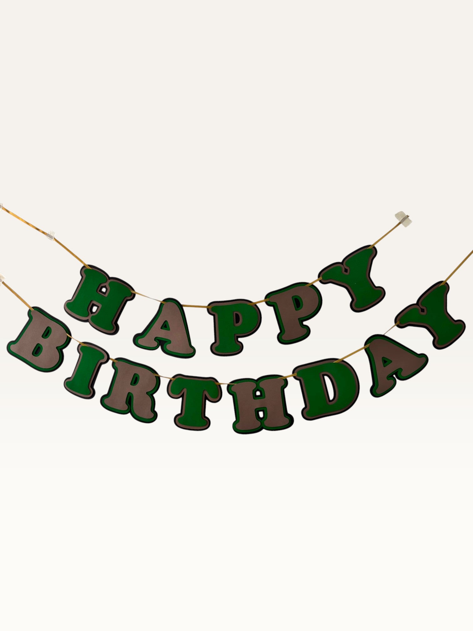 Paper Party Studio green and brown layered paper Happy Birthday banner with dimensional cut-out letters on a cord.