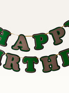 Paper Party Studio layered green and brown Happy Birthday banner with dimensional cut-out letters on a cord.