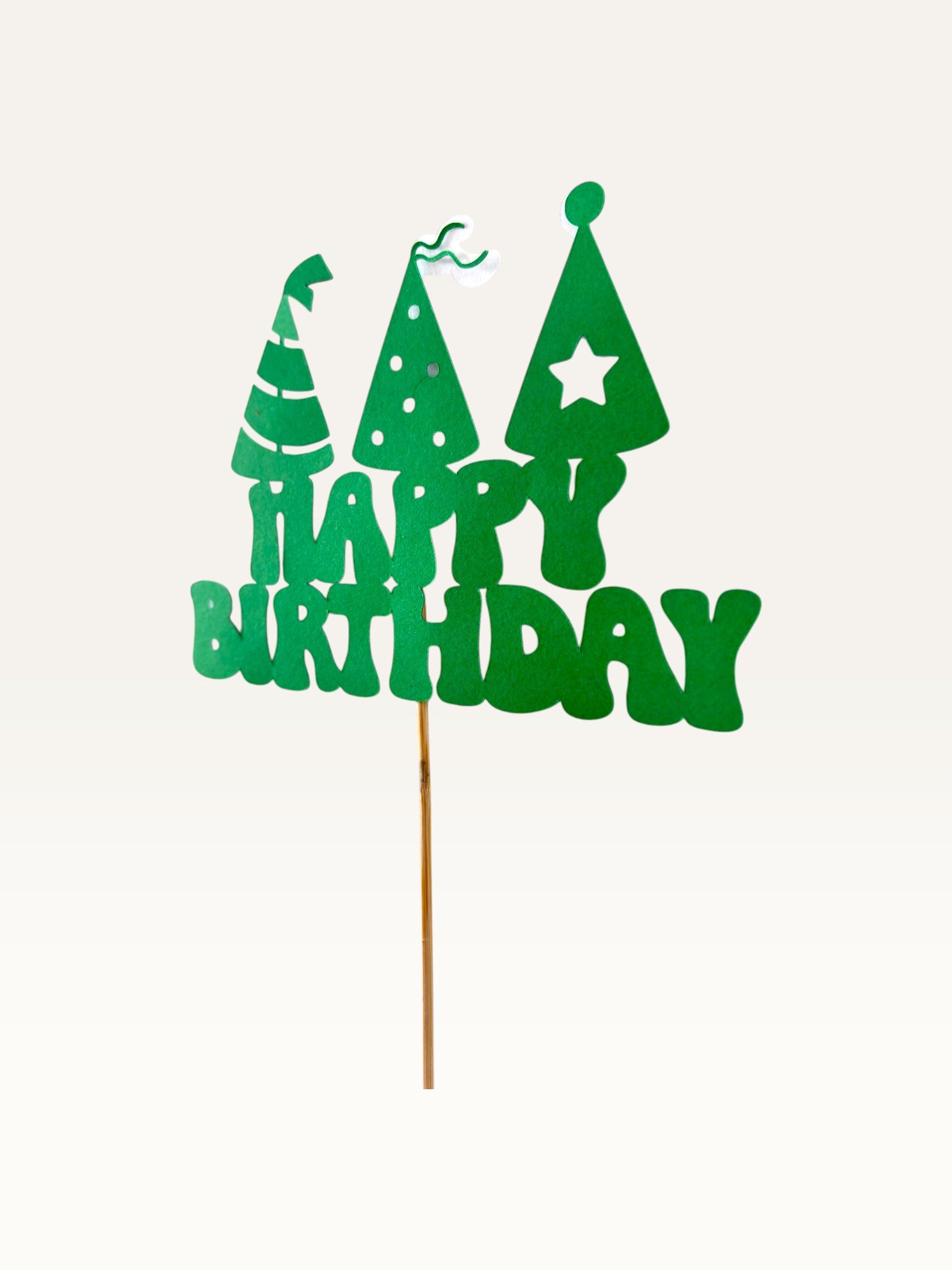 Paper Party Studio green Happy Birthday cake topper with three party hat cut-outs on a wooden pick