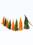 Paper Party Studio handmade tissue paper tassel garland in green and orange for party decorations and backdrops.