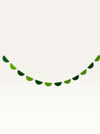 Paper Party Studio green scallop string garland for jungle safari birthday party decorations