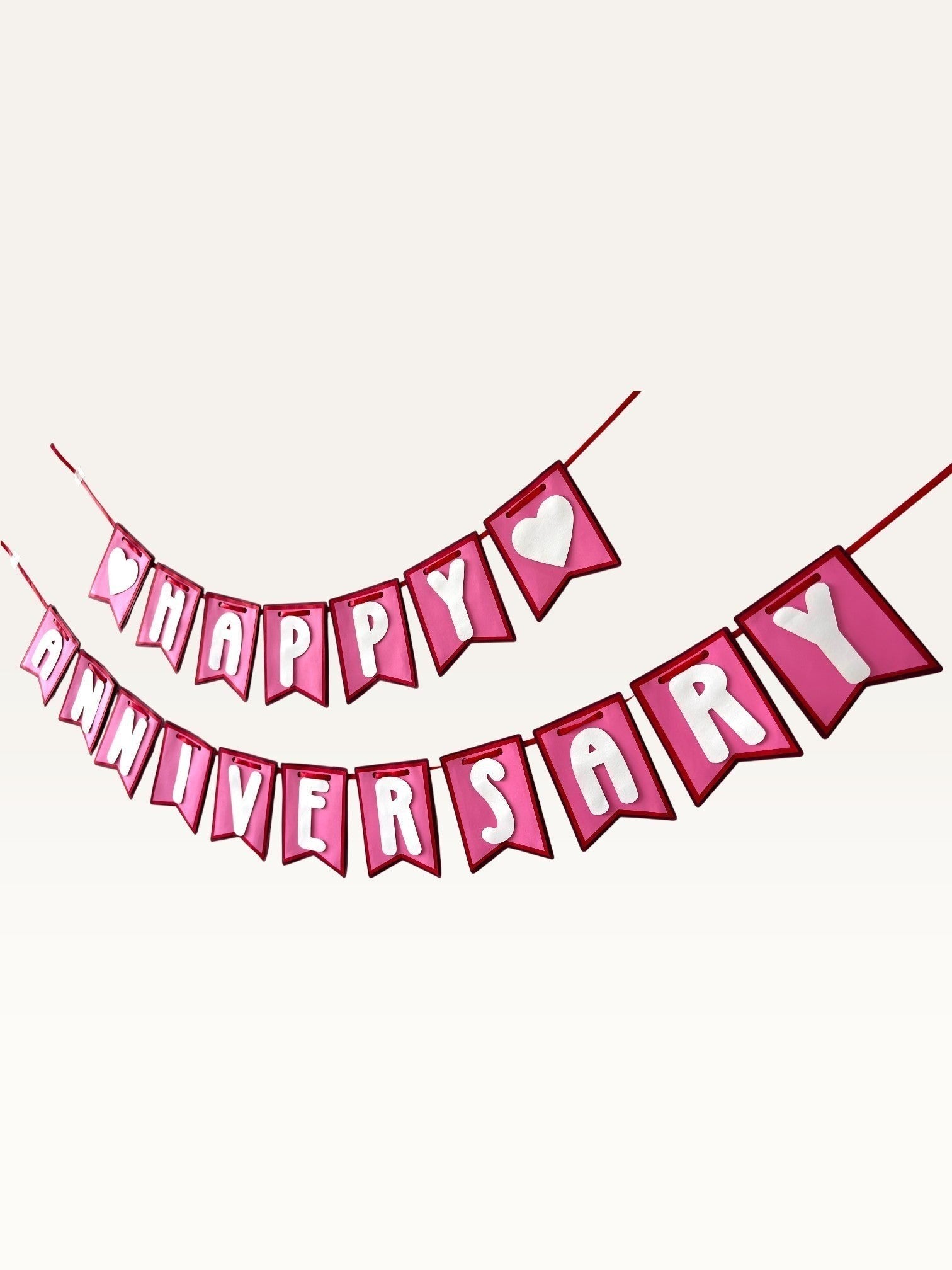 Paper Party Studio pink and white Happy Anniversary cardstock bunting banner with heart accents on swallowtail flags.