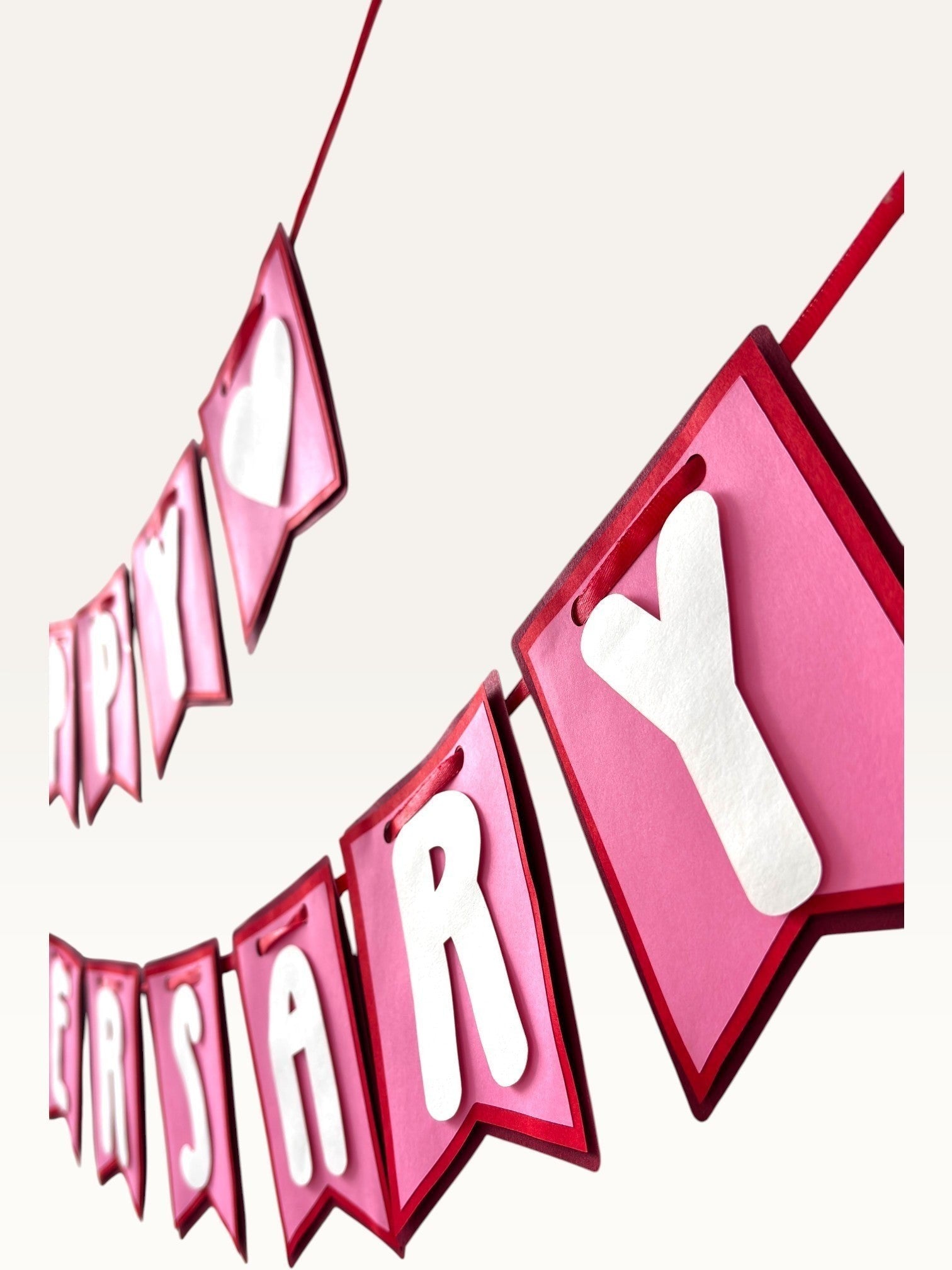 Paper Party Studio Happy Anniversary banner with pink swallowtail cardstock flags and white 3D heart and letter accents